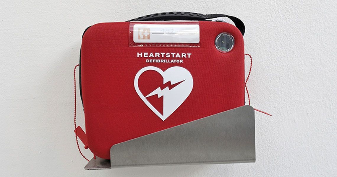 A red Automated External Defibrillator