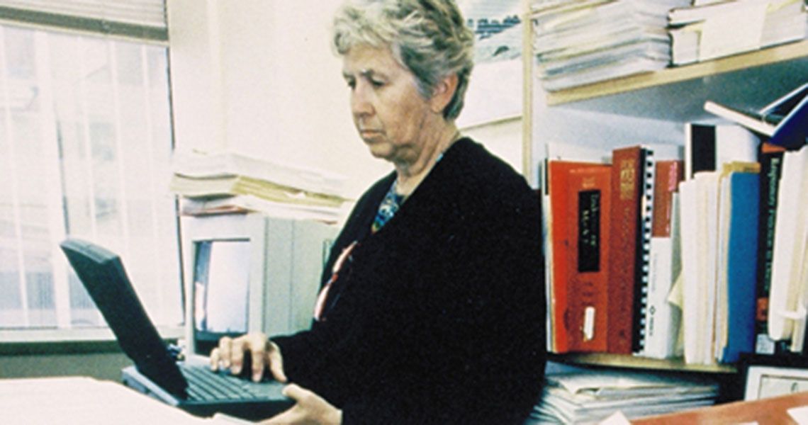 Dr. Jean Fourcroy typing on a laptop