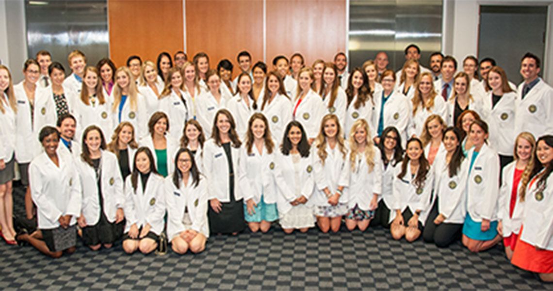 Physician Assistant Studies students pose in white coats