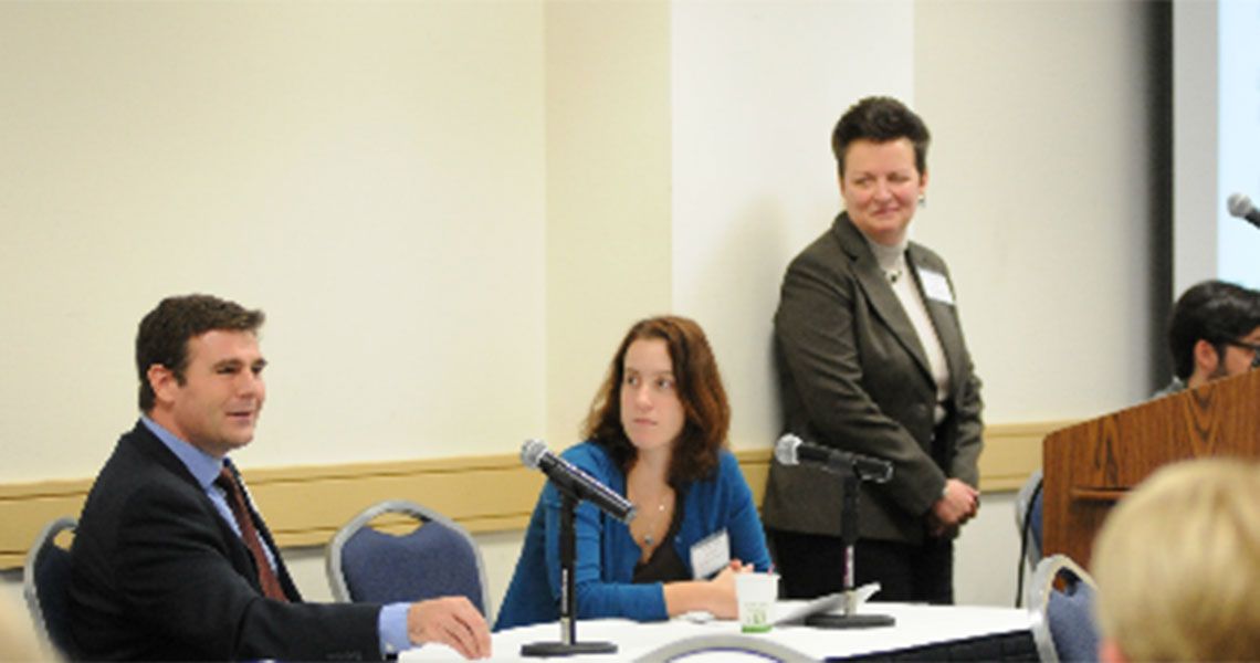 Panelists sitting at a table in a conference room