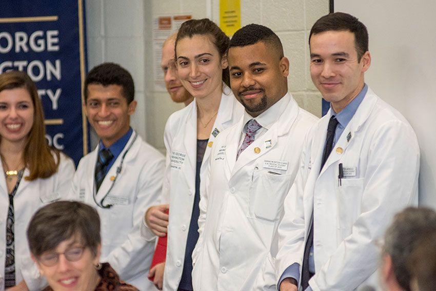 GW Public Health students in white coats standing together