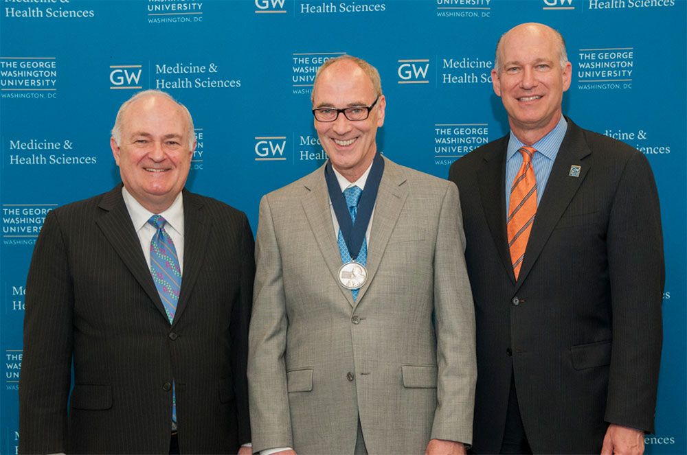 President Steven Knapp, Robert H. Miller, and Dean Jeffrey S. Akman pose together