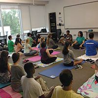 Shivani Shah sitting with others in a yoga class