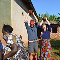 Adam Spring and Anne Waldrop standing together outdoors in Uganda