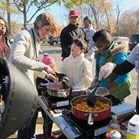 Madden Rowell serves food to community members