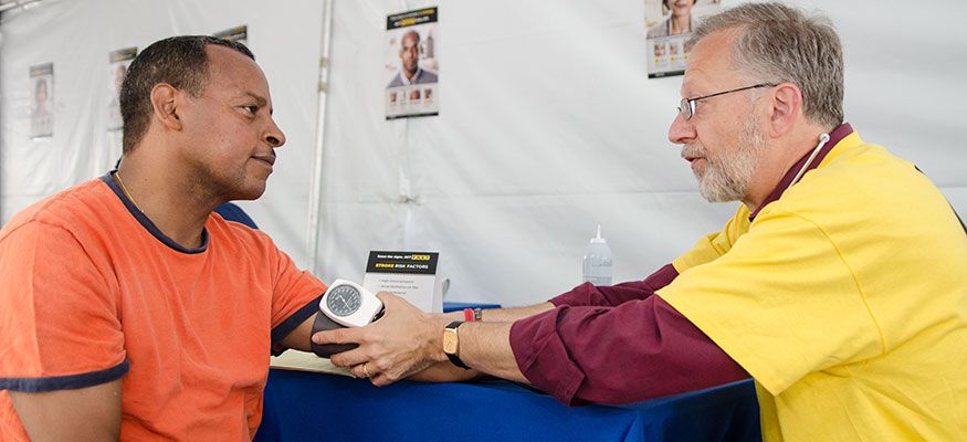 A patient receiving a blood pressure exam from Dr. Kaminsky