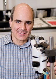 Dr. Anthony LaMantia posing for a portrait in a laboratory
