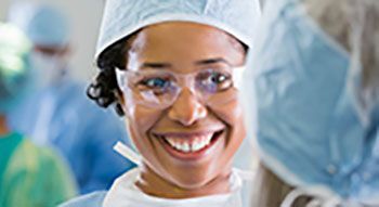A smiling medical working wearing PPE