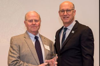 Dr. Robert J. Neviaser holding an award next to Dr. Jeffrey S. Akman