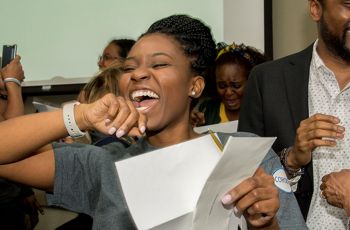 A SMHS student holding an envelope and reacting with joy to her medical residency match