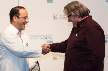 Dr. Babak Sarani shaking hands with patient Wayne Millner