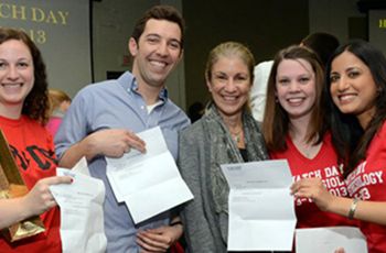 Students pose with match letters and Dean Goldberg