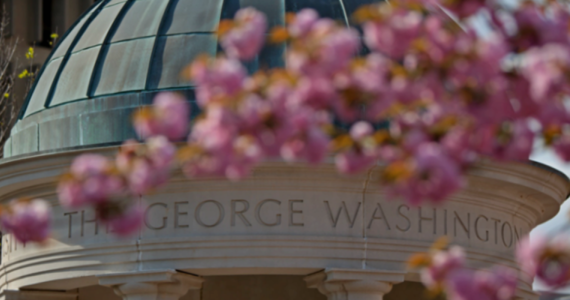 George Washington University campus with pink blossoms in the foreground