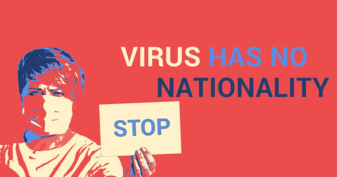 Virus has no nationality | Woman holding a sign that says 'stop'