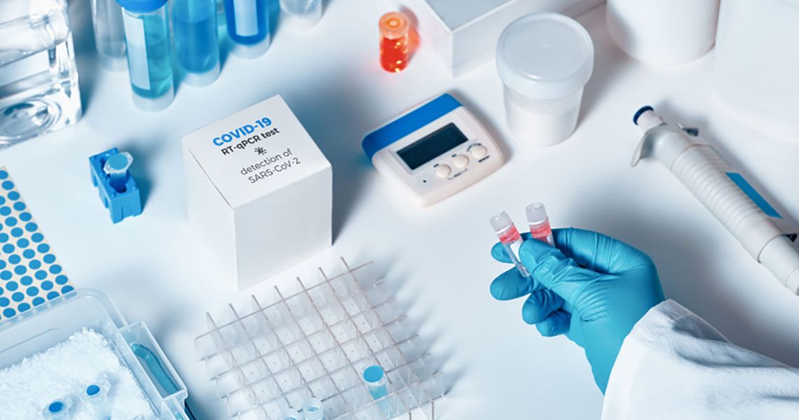A medical table containing sample analysis objects and a COVID-19 pcr test