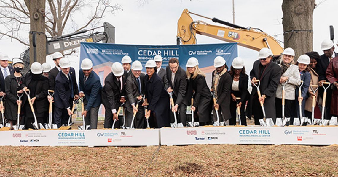 Mayor Muriel Bowser and others stab shovels into the site of the Cedar Hill Regional Medical Center