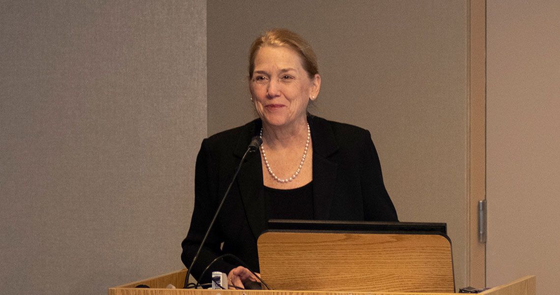 Dean Barbara Bass speaking from a podium