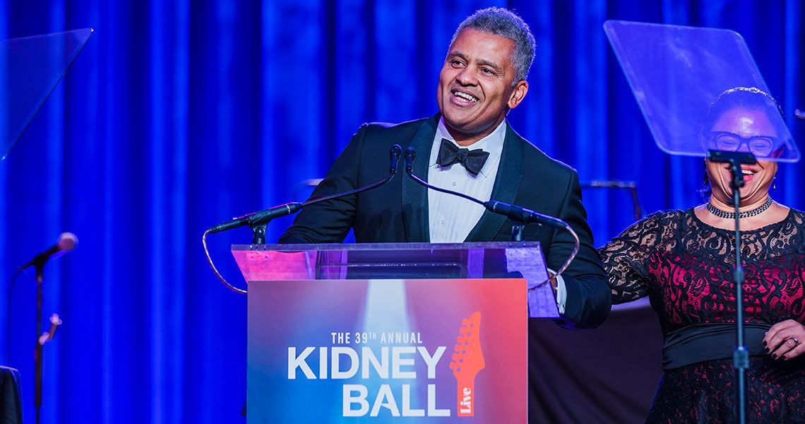 Dr. Keith Melancon speaking from a podium that reads 'The 39th annual kidney ball'
