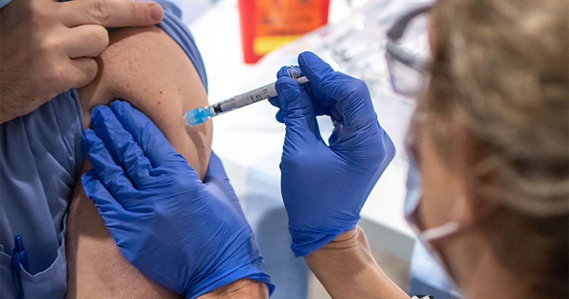 Person receiving a vaccine shot in the arm
