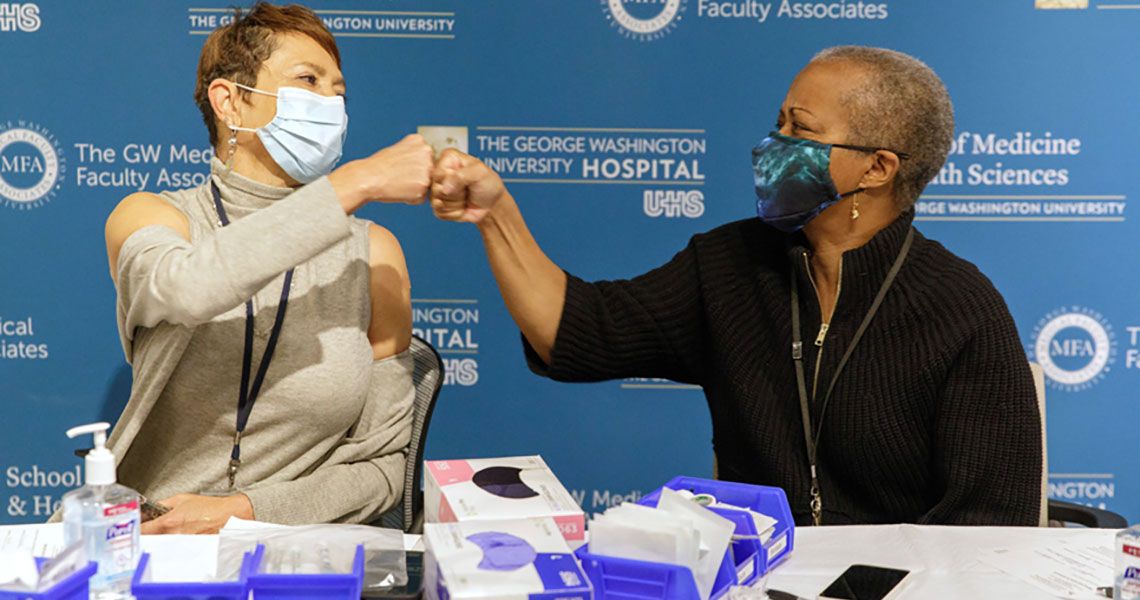 Drs. Haywood and Williams fist bumping after receiving COVID-19 vaccines