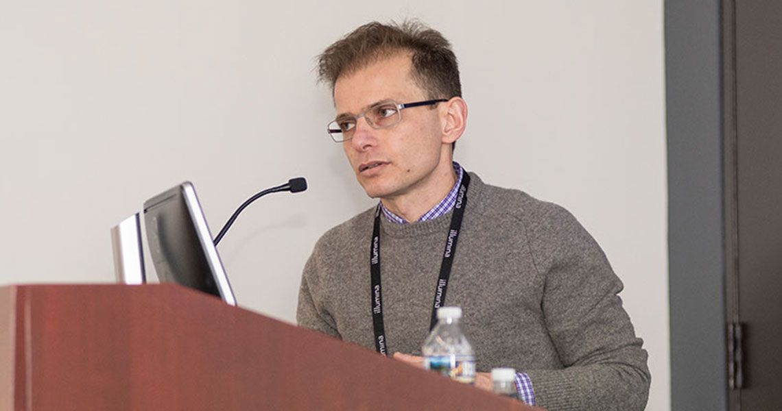 Dr. Alexander Tzatsos speaking from a podium