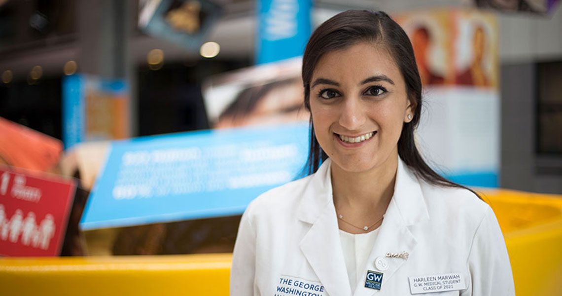 Harleen Marwah posing for a portrait in a white coat