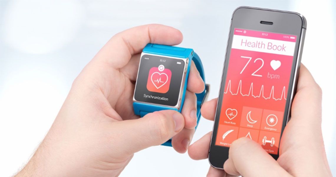 A person holding a smartphone and a smart watch displaying heart health data