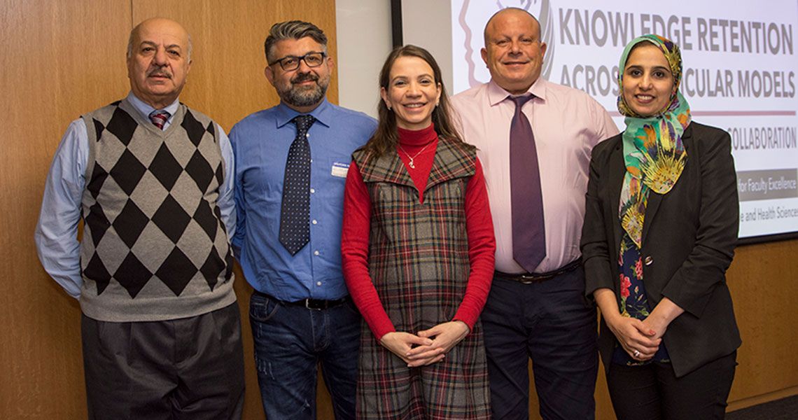 Dr. Rosalyn Jurjus standing with visiting attendees of the Knowledge Retention Across Circular Models symposium