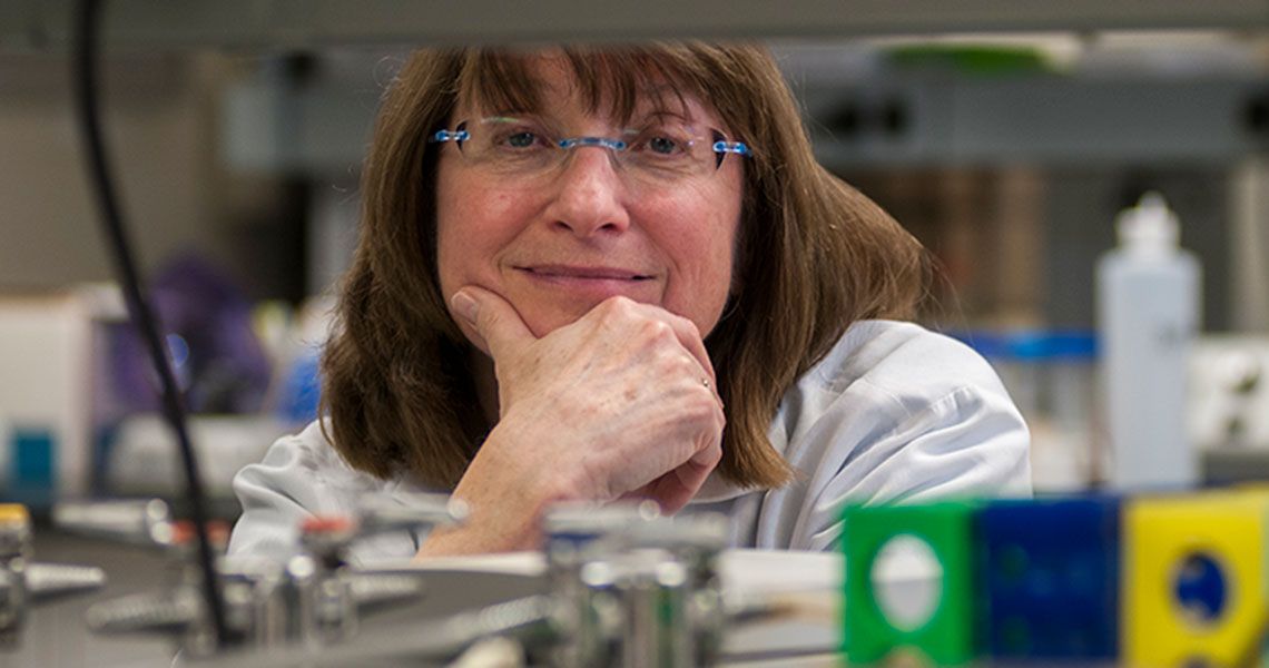 Dr. Sally Moody posing for a portrait in a laboratory