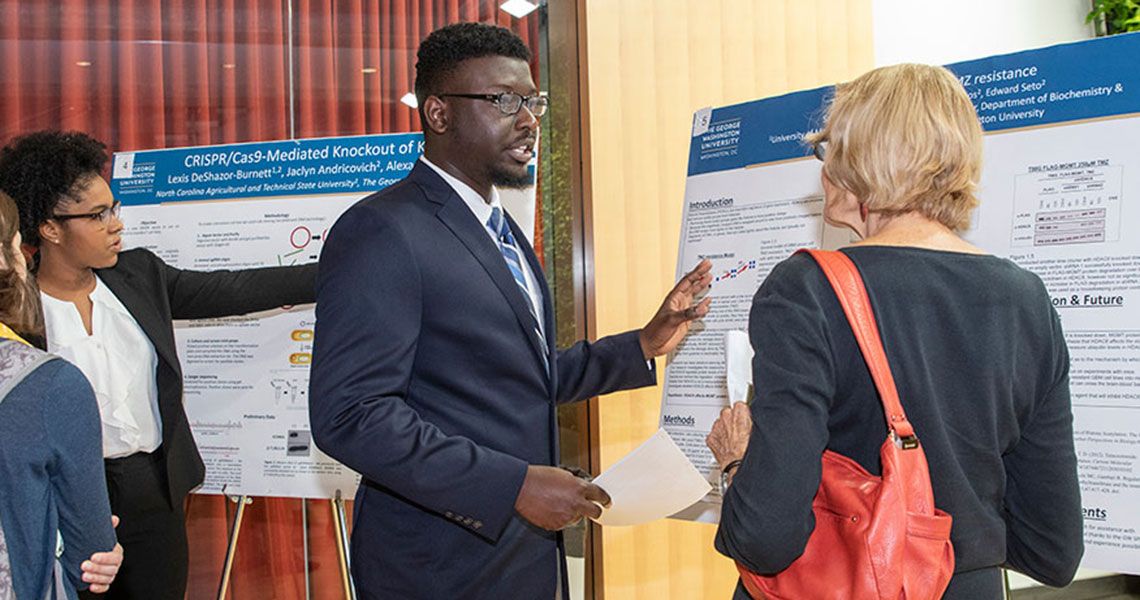 Two GW medical students presenting their research posters