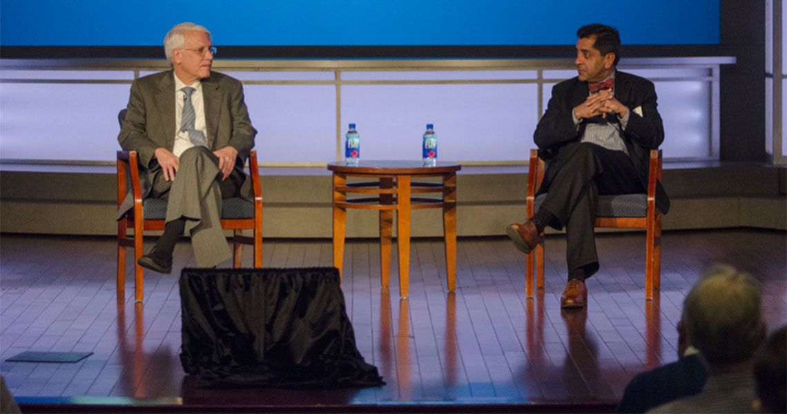 Drs. Anthony Caputy and Raj Rao sitting on a stage