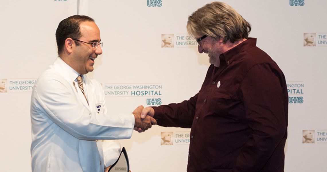 Dr. Babak Sarani shaking hands with patient Wayne Millner