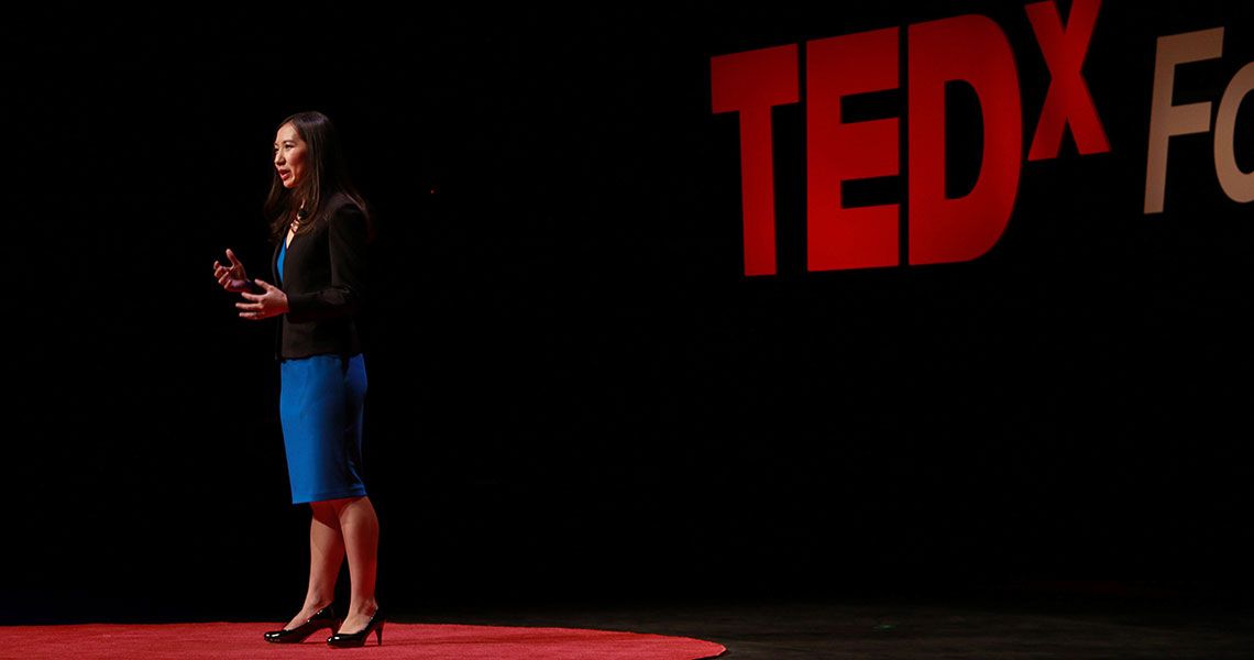 Dr. Leana Wen speaking to an audience on the TED X Foggy Bottom stage