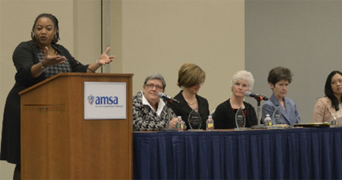 Katherine Chretien, Carolyn Clancy, Laura Tosi, and others at a panel table and podium