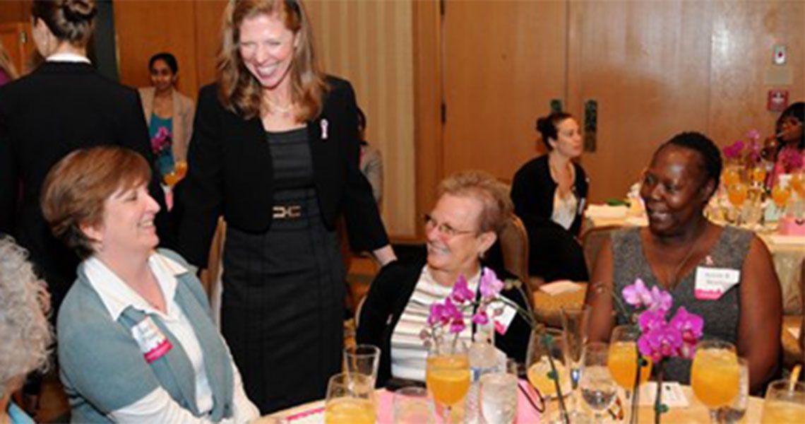 Breast Care Center luncheon participants talking at a table