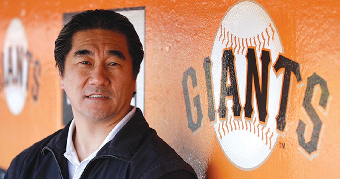 Dr. Ken Akizuki posing for a portrait in the San Francisco Giants dugout