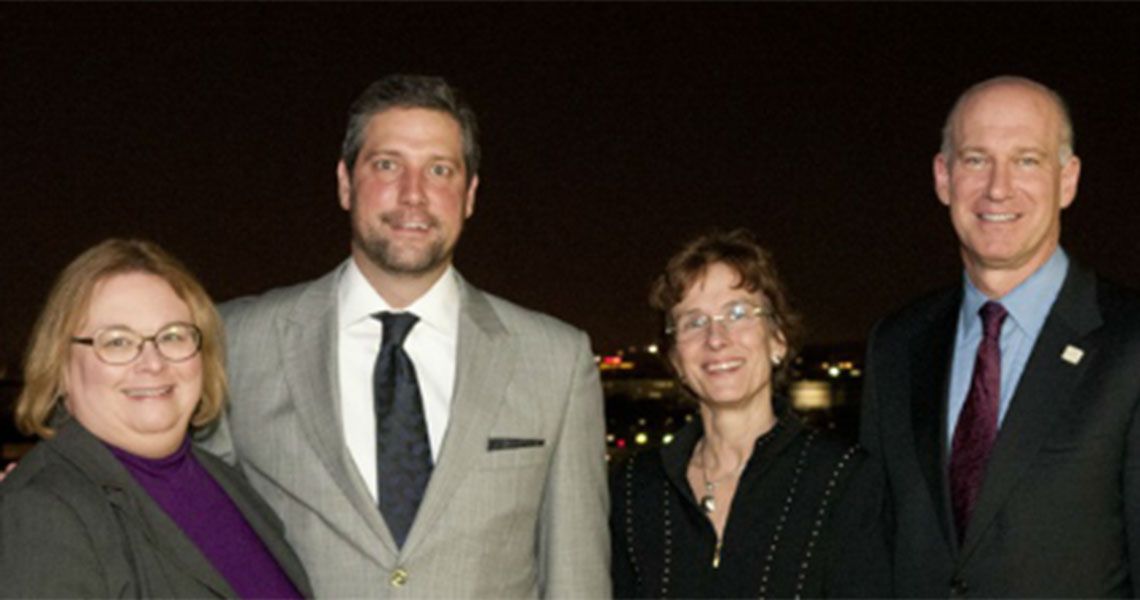 Christina M. Puchalski and Dean Akman pose for a photo with two people
