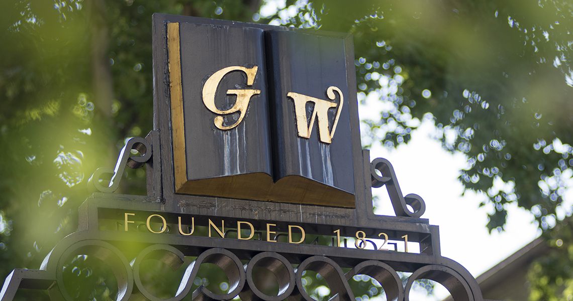 GW symbol on a campus gate overlooking campus