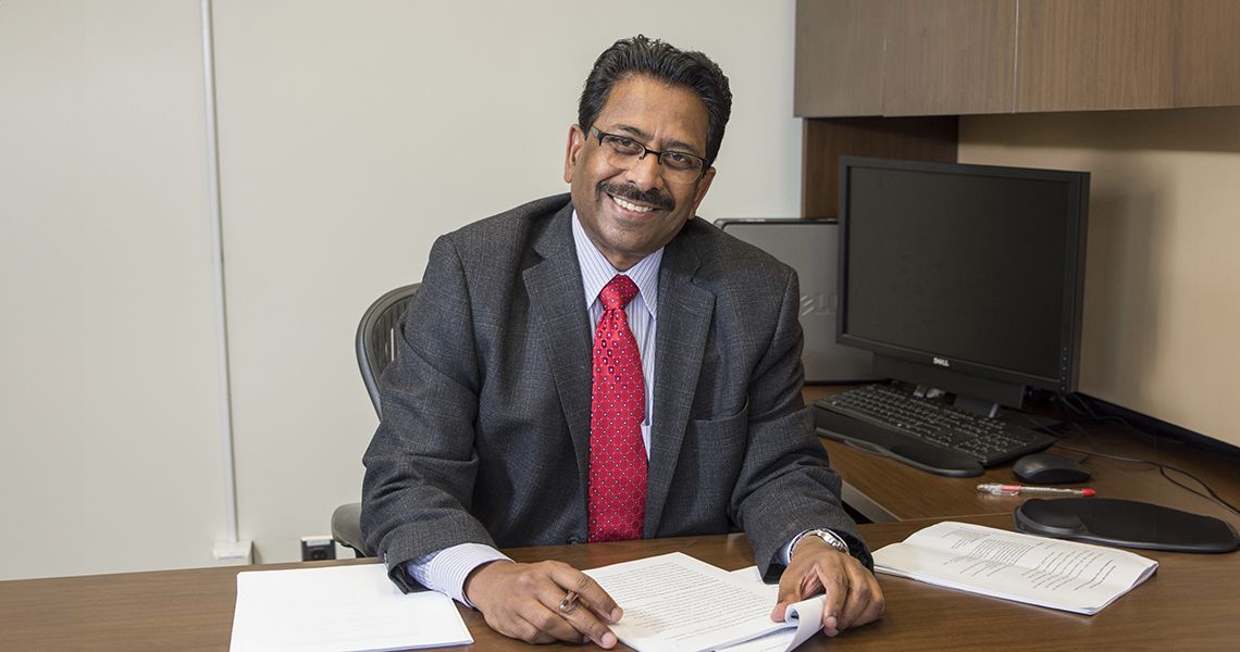 Dominic Raj, MD, in his office