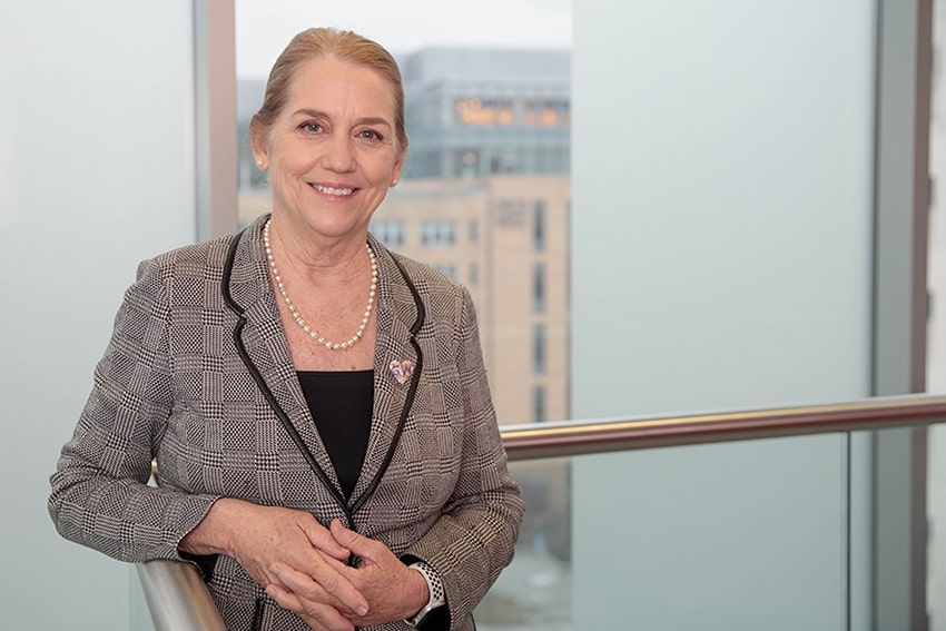 Barbara Bass smiling in front of a window