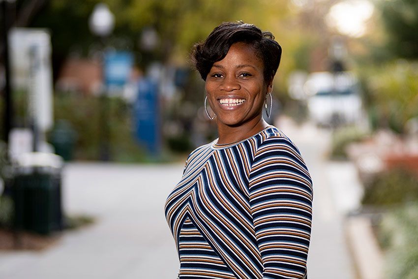 Dr. Grace Henry standing for a portrait on the GW campus