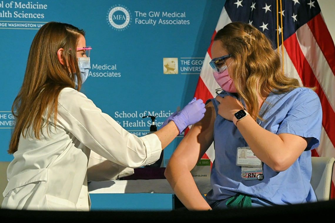 Shylee Stewart, RN, receives a COVID-19 vaccination