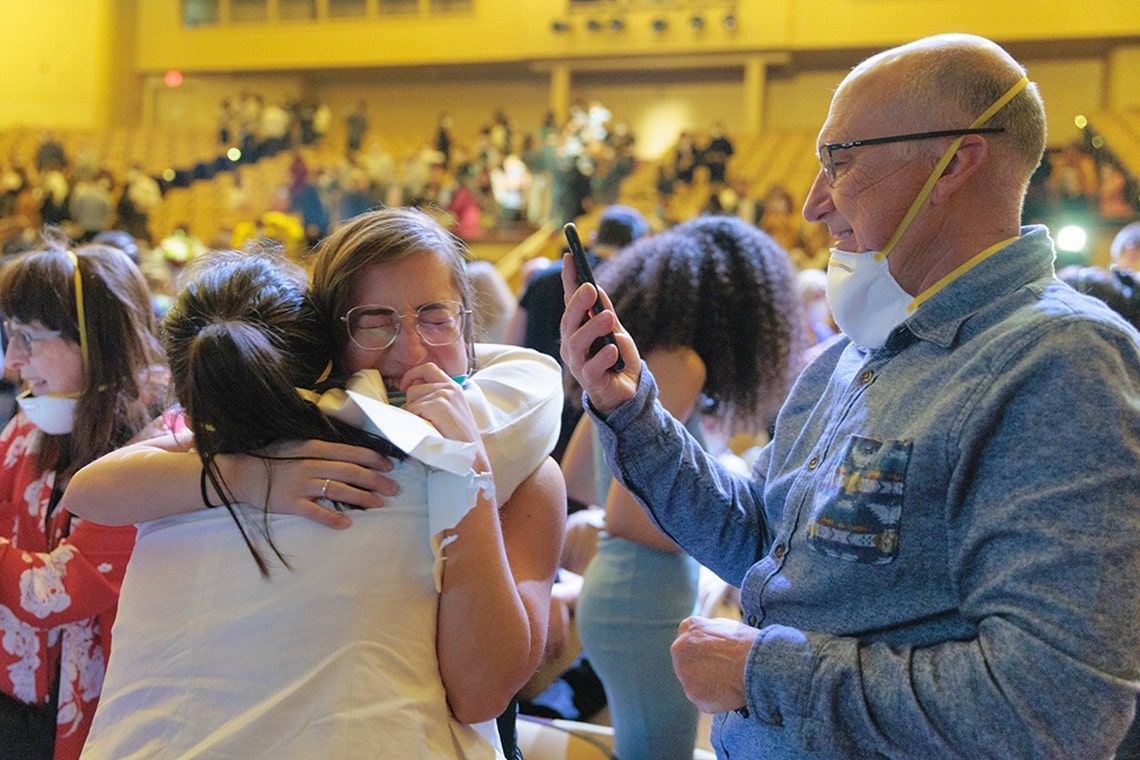 A medical student is hugged by their parents after receiving their match