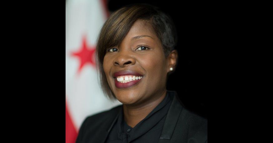 Dr. Nesbitt posed for a portrait in front of a flag