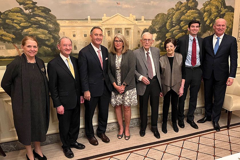 Standing together in front of a mural of the White House are SMHS Dean Barbara L. Bass, President Mark S. Wrighton, Jonathan B. Perlin, Donna J. Perlin, Seymour Perlin, Ruth R. Perlin, Connor R. Perlin and Jeffrey S. Akman