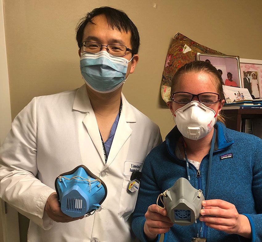 Drs. Yuan Rao and Destie Provenzano stand together wearing masks