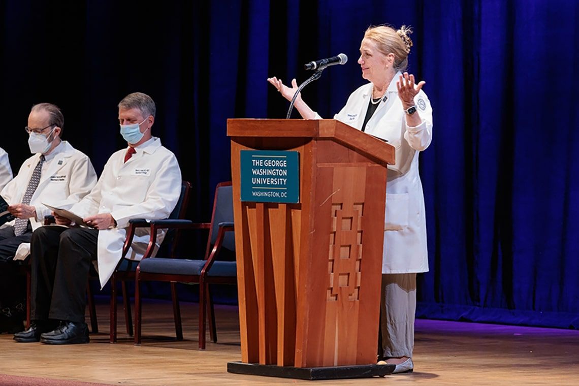 Dean Bass speaking from a podium at the class of 2024 White Coat ceremony