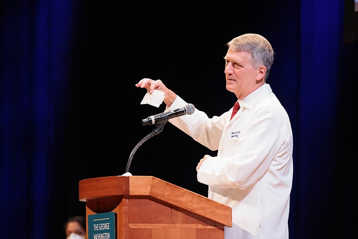 Keynote speaker Hal Frazier II, MD speaking from a podium at the class of 2024 White Coat ceremony