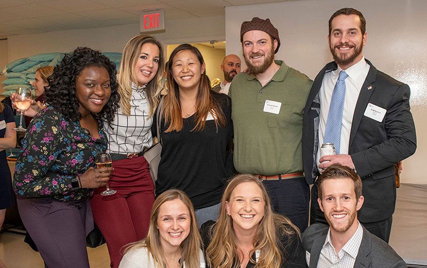 Eight GW Physical Therapy alumni stand together 