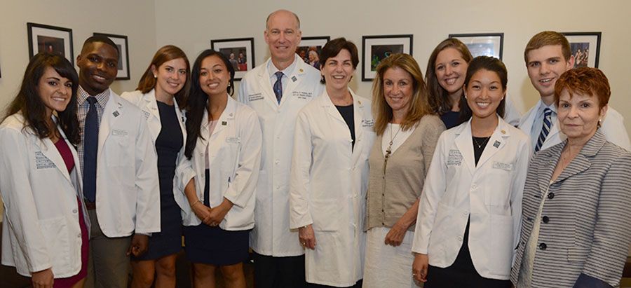 Dean Akman, Dean Goldberg, and Dean McQuail pose with students 